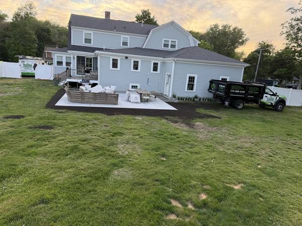 Spacious poured-concrete patio and freshly leveled lawn