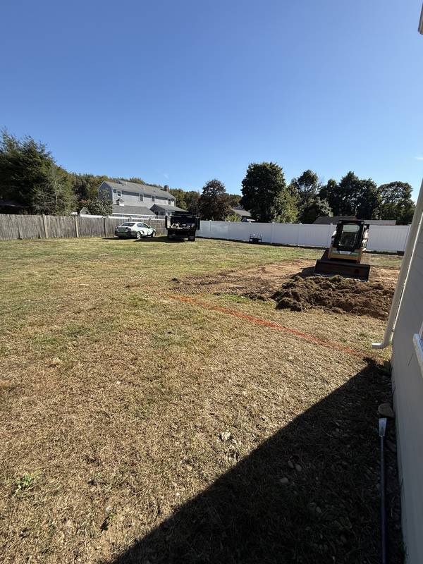 Patio footprint being excavated with a compact loader