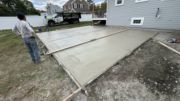 Screeding the fresh concrete inside the forms