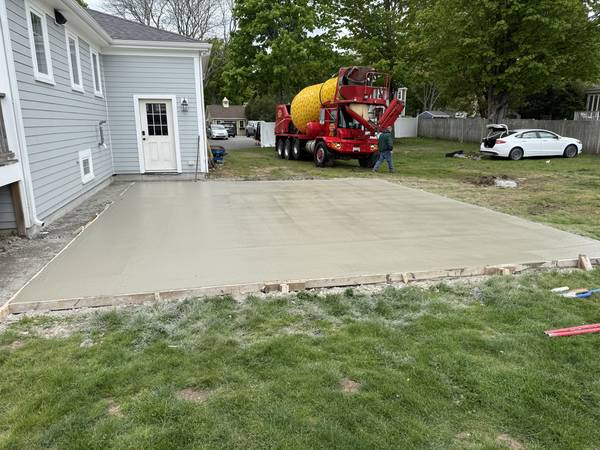 Concrete poured and finished alongside the house