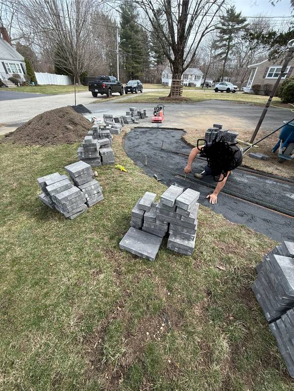 Excavated path with fabric and base ready for pavers