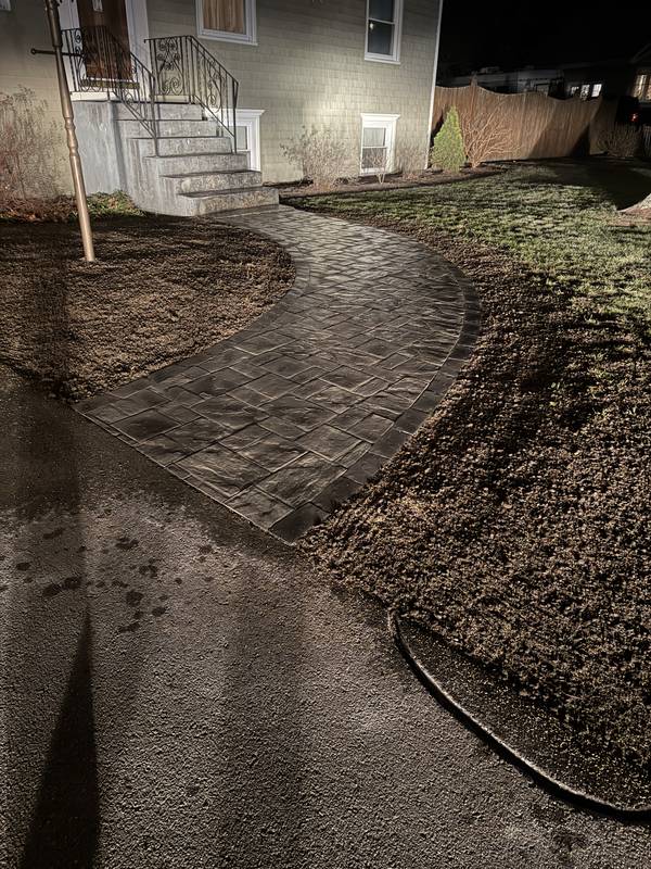 Finished curved paver walkway leading to the front steps