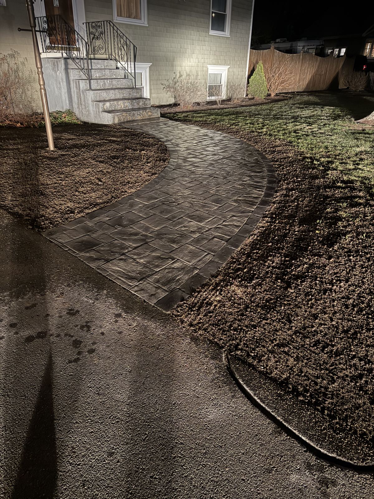 Finished curved paver walkway leading to the front steps