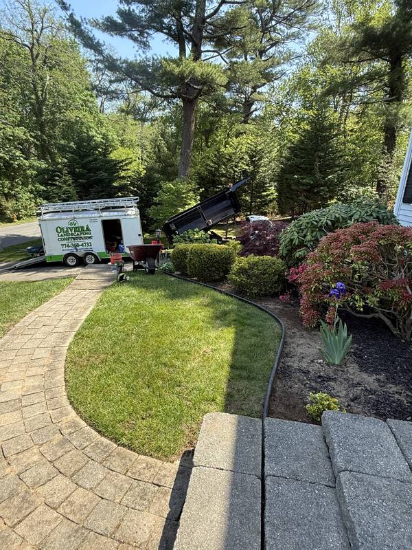 Finished beds and lawn along the paver walkway