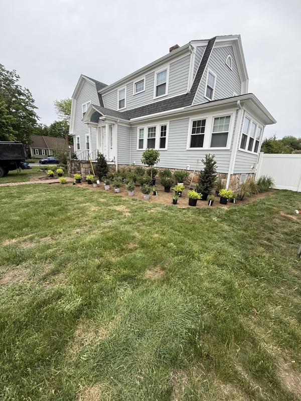 Foundation beds wrapped around the side of the home