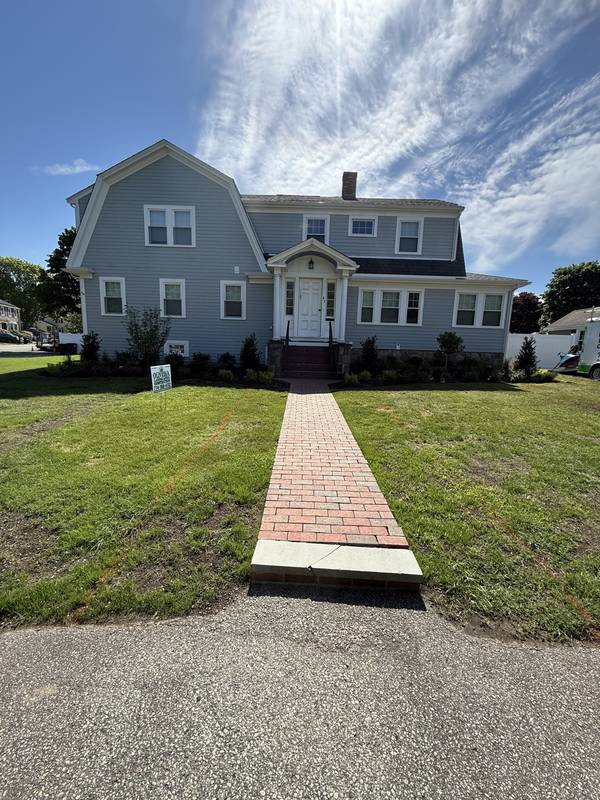 Red brick walkway leading to the front entrance