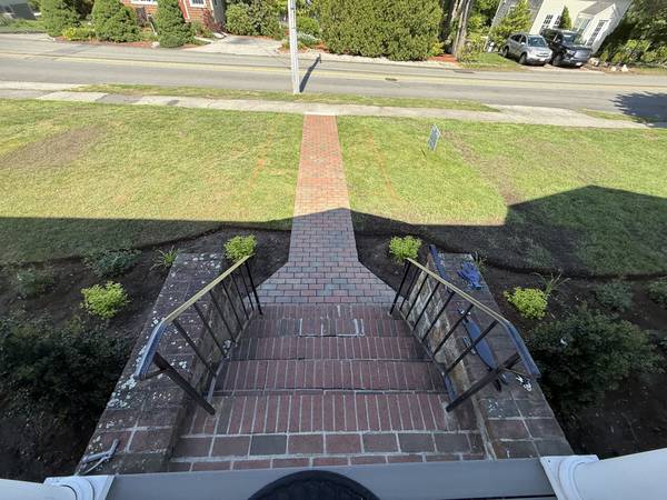 Brick steps and walkway with fresh plantings on both sides