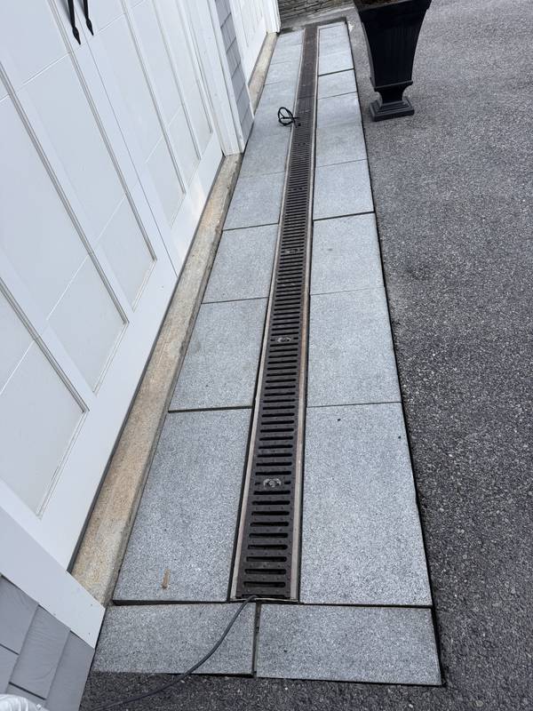 Flush trench drain between granite pavers