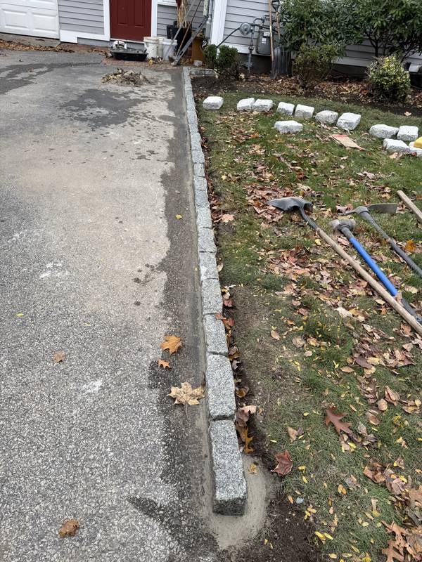 Setting granite cobbles along the driveway