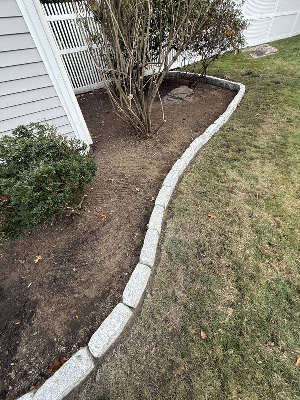 Granite edging following the curve of a shrub bed