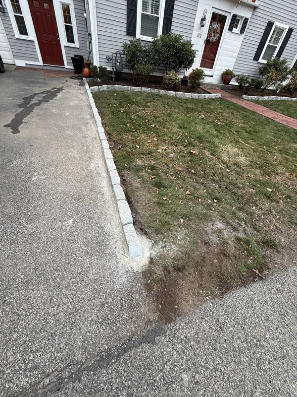 Granite curb line separating driveway and lawn