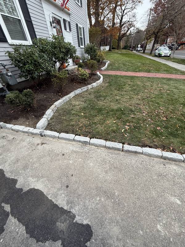 Curved granite bed border along the front walk