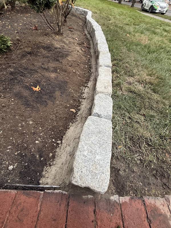 Granite edge meeting the brick walkway
