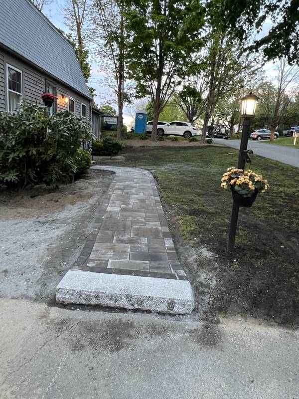 New paver walkway with a granite step at the driveway