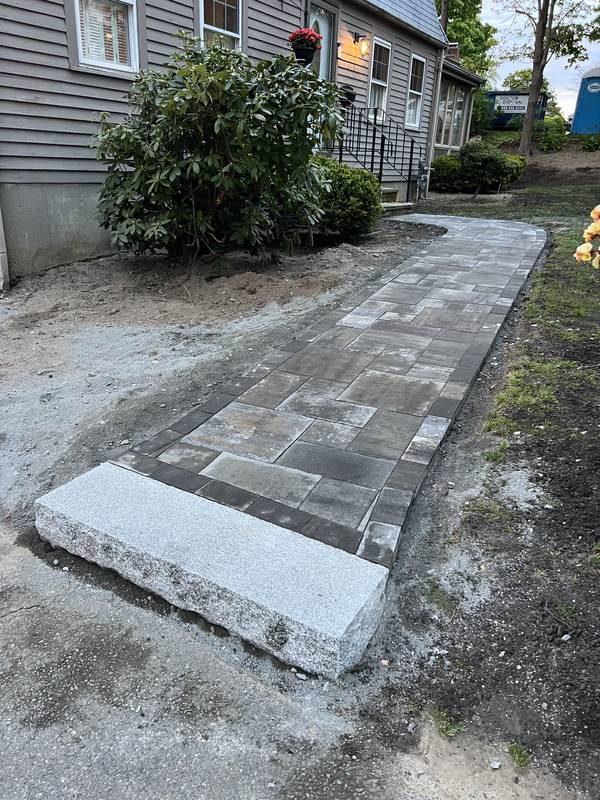 Paver walkway set along the front of the home