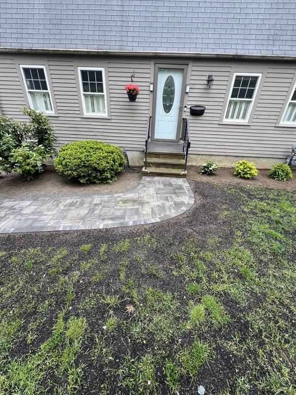 Paver landing at the front door with seeded lawn