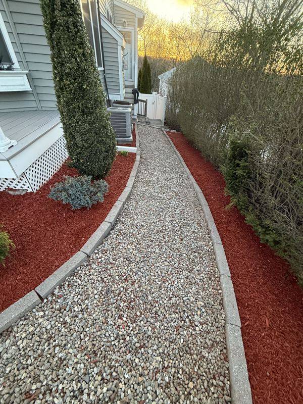 Detailed bed work along the property's stone walkway