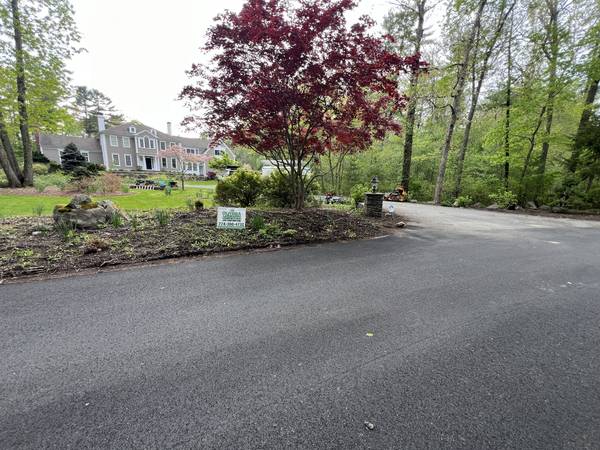 Clean bed lines along the curving driveway
