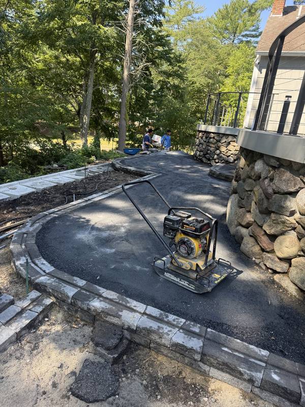 Compacting the base and setting the first paver borders