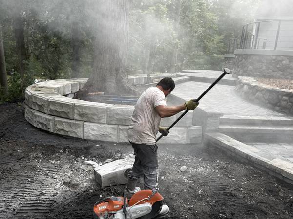 Cutting and fitting the raised stone tree ring on site