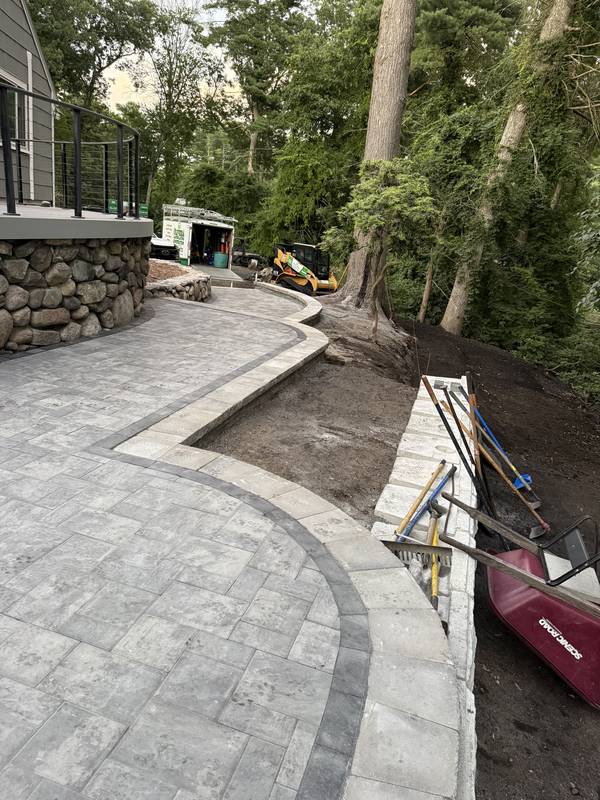 Clean paver lines with a charcoal soldier-course border