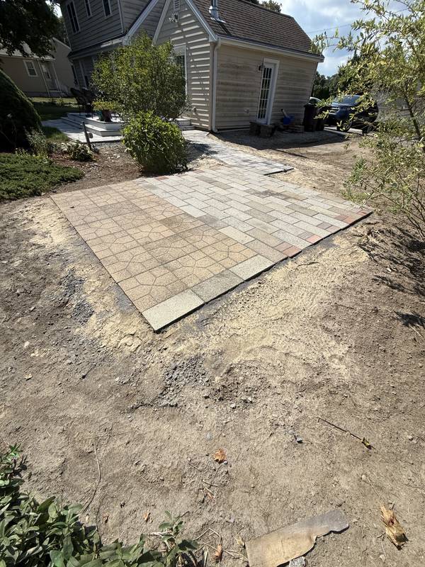 New paver patio pad set into the graded yard