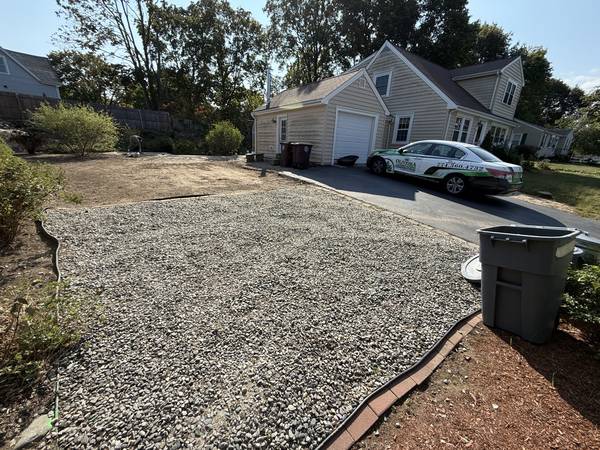 Crushed-stone parking area with steel-edged mulch bed