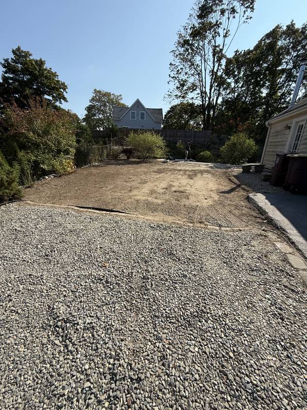 Extended gravel parking pad beside the driveway