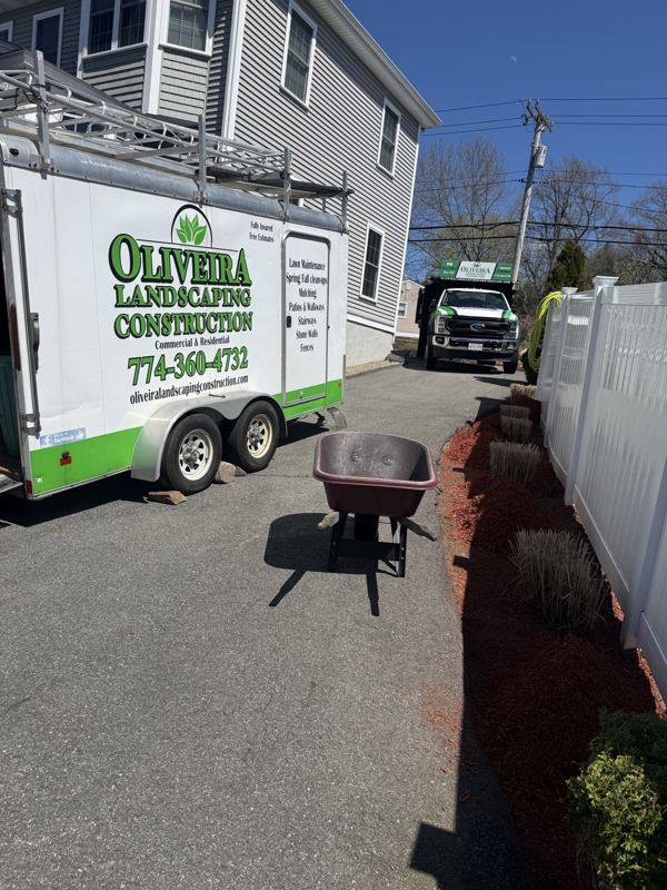 Oliveira Landscaping crew truck on-site at the finished walkway project