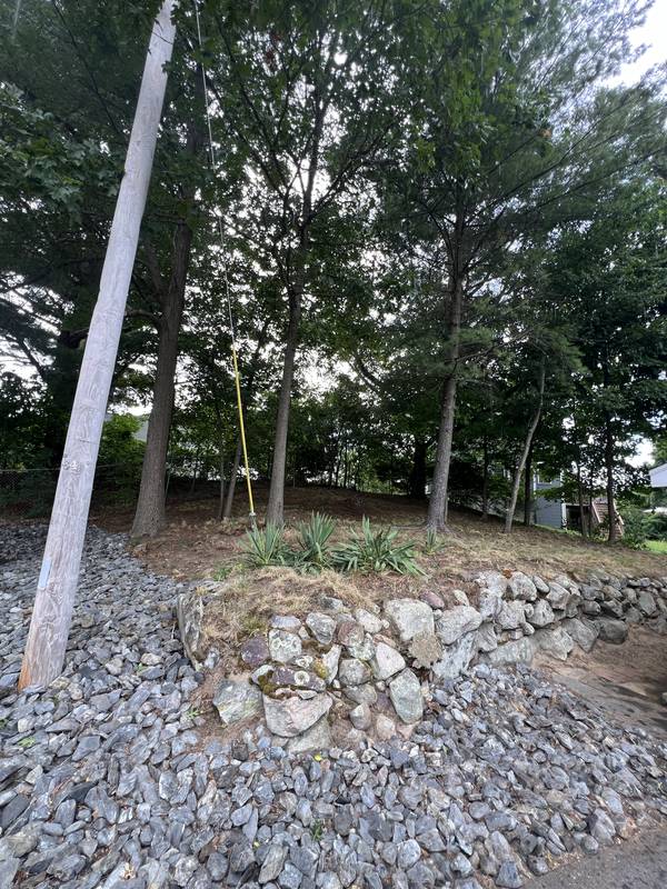 Stone wall and riprap going in at the corner