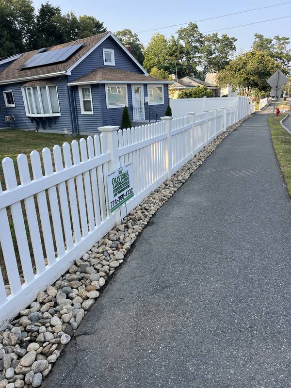 River-stone border under the picket fence
