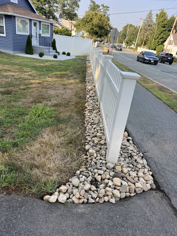 River stone at the fence corner and walkway