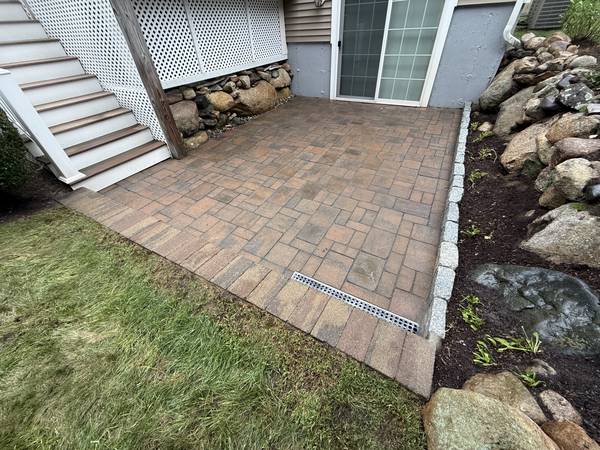 Patio, drain and granite edge seen from the lawn