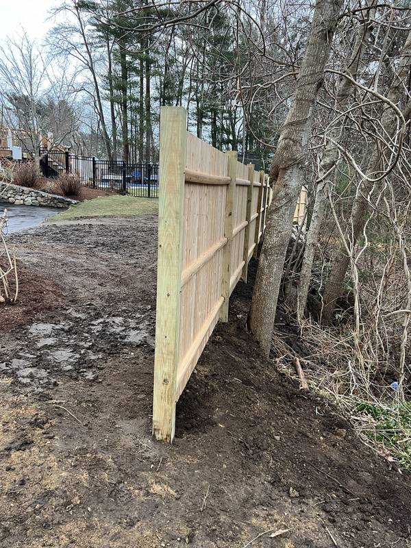Finished wooden privacy fence along the property line