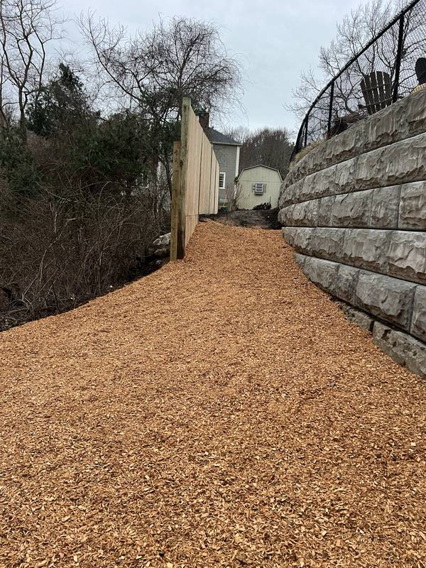 Wood-chip path along the block retaining wall